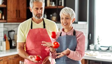 kitchen woman man couple food preparing vegetable home love senior husband wife vitality active cooking healthy carefree diet meal playful