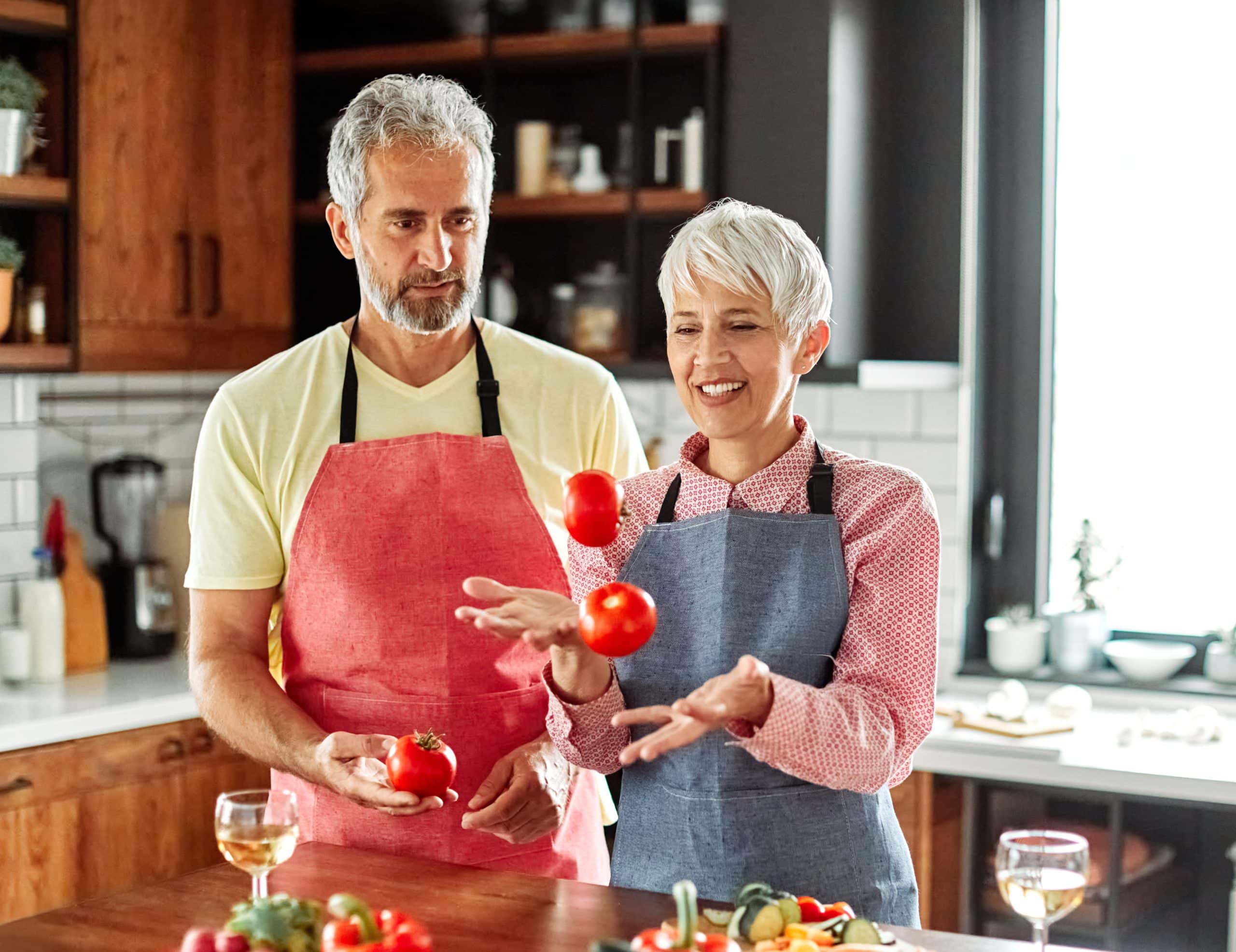 kitchen woman man couple food preparing vegetable home love senior husband wife vitality active cooking healthy carefree diet meal playful