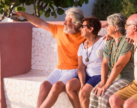 group of four mature people having fun together taking a selfie