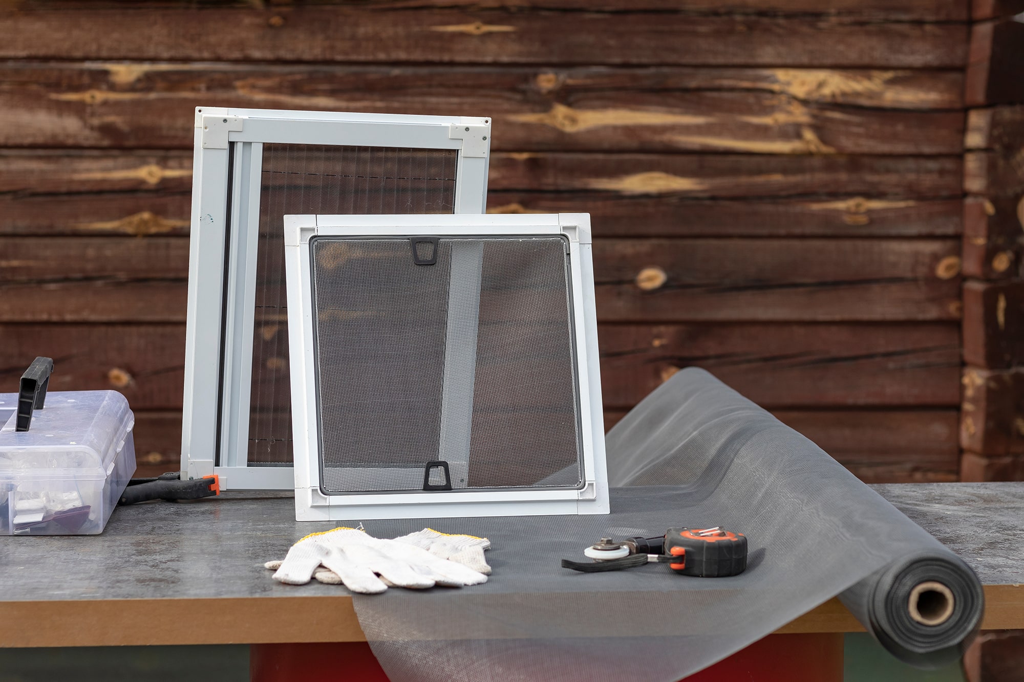 Mosquito nets samples. On open air. The desktop on which the products will be assembled on the window. In the background a wooden background in retro burgundy color style