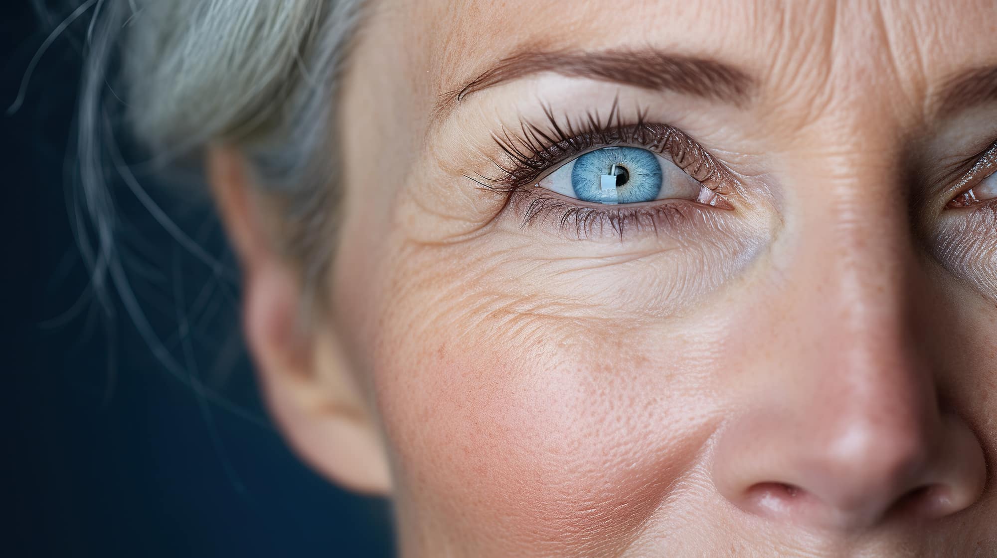 Closeup portrait of a beautiful older woman's blue eyes. Healthy