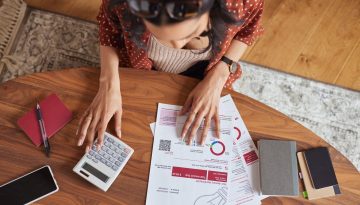 Woman calculating financial bill at home