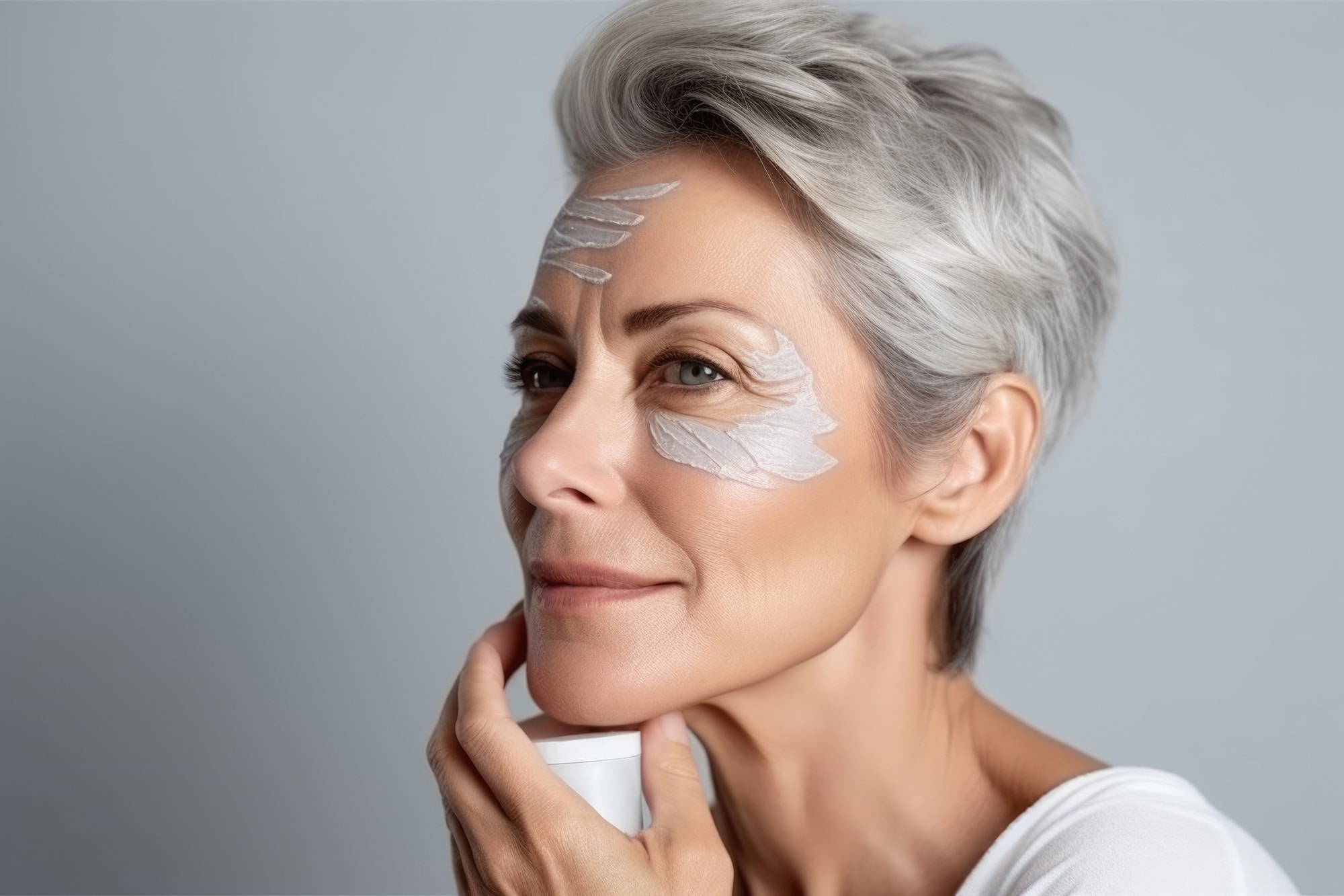 Portrait of a fifty year old woman with rejuvenation cream appli