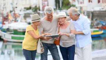 Senior couples looking at map on traveling journey