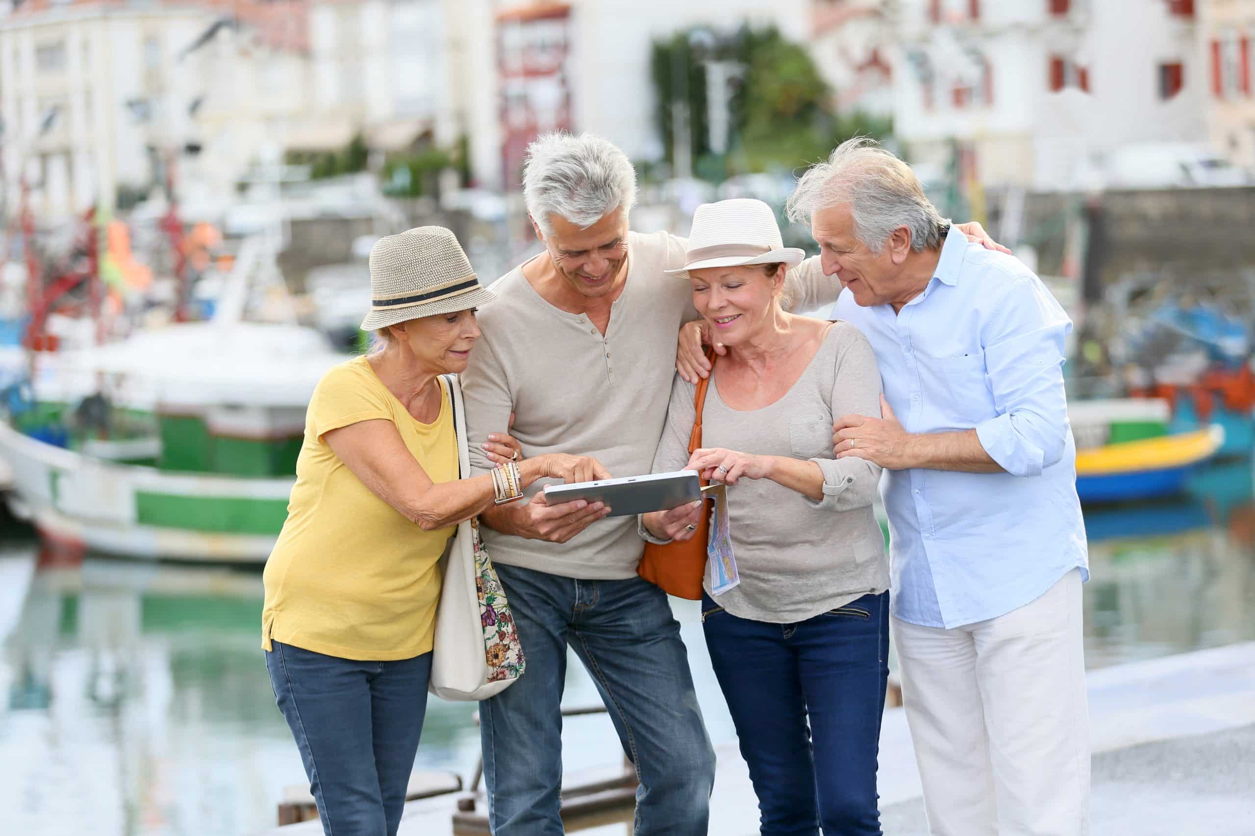 Senior couples looking at map on traveling journey