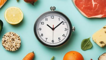 Nutrient-rich foods surrounding a stopwatch, concept of longevit