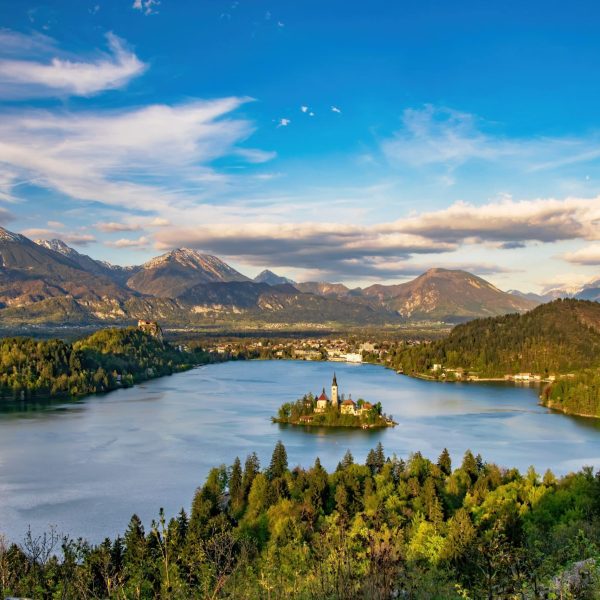 Panoramic view of Lake Bled from Ojstrica Hill, at sunny day with beautiful clouds on background, Slovenia