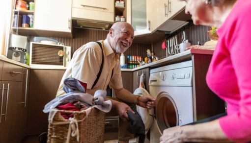 Senior man doing the laundry at home