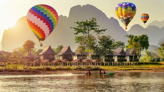 Hot air balloon over Nam Song river at sunset in Vang vieng, Lao