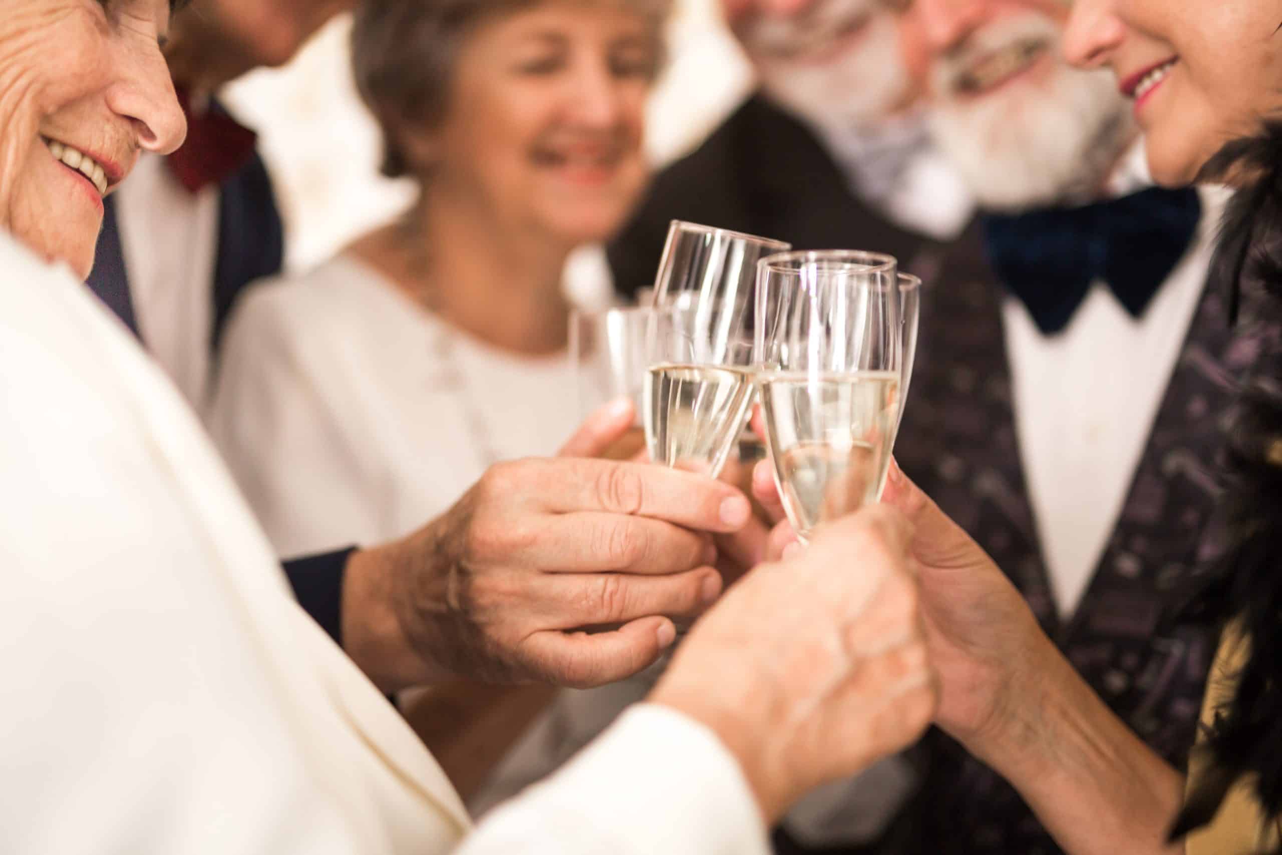 Group of older happy friends toasting with champagne during New