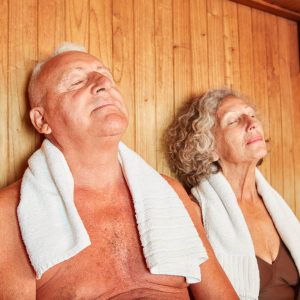 Relaxed senior couple enjoying the healthy heat in the wellness sauna